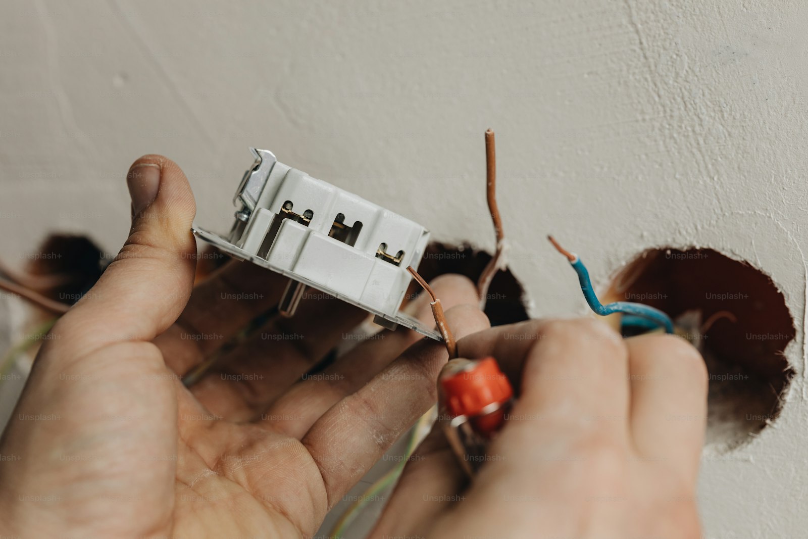 Professional electrician working in a Swindon home
